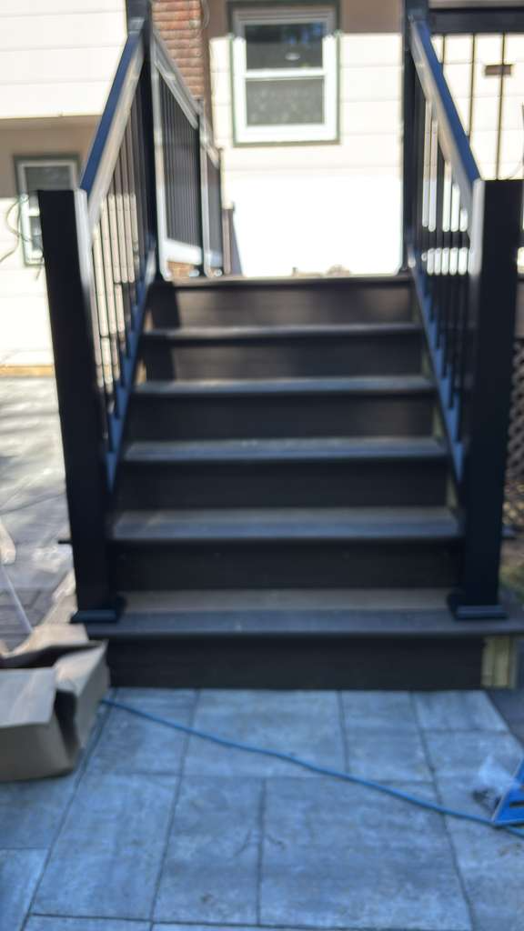 Black composite deck stairs with metal balusters